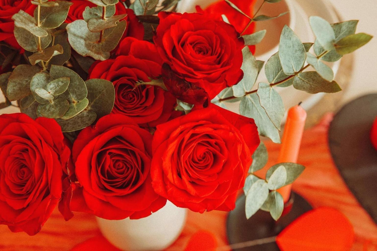 Professional floral designer creating intricate wedding arrangements